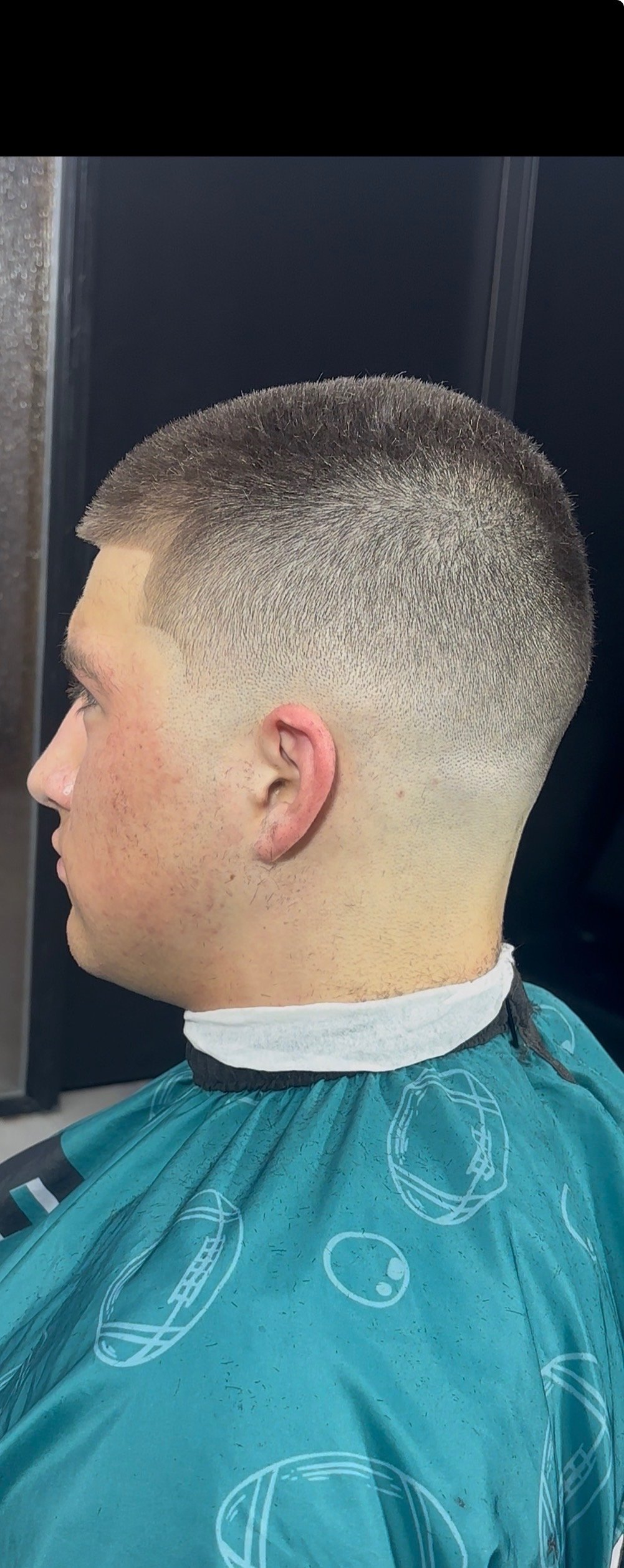 Buzz fade haircut, side profile